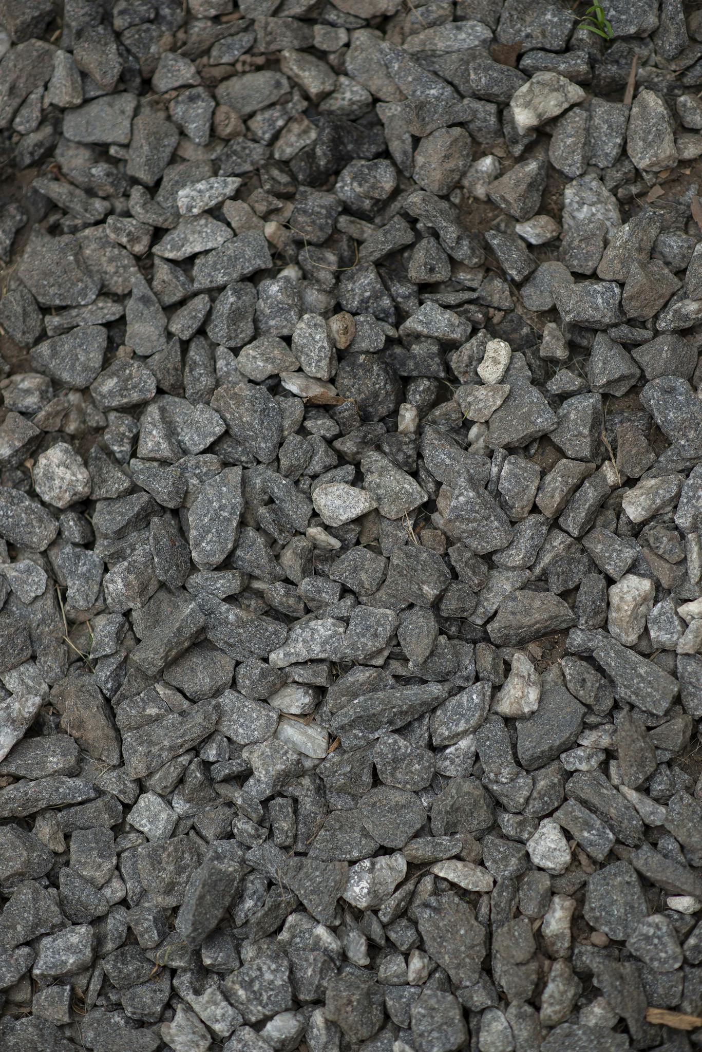 Close-up view of scattered gravel stones, perfect for background use.