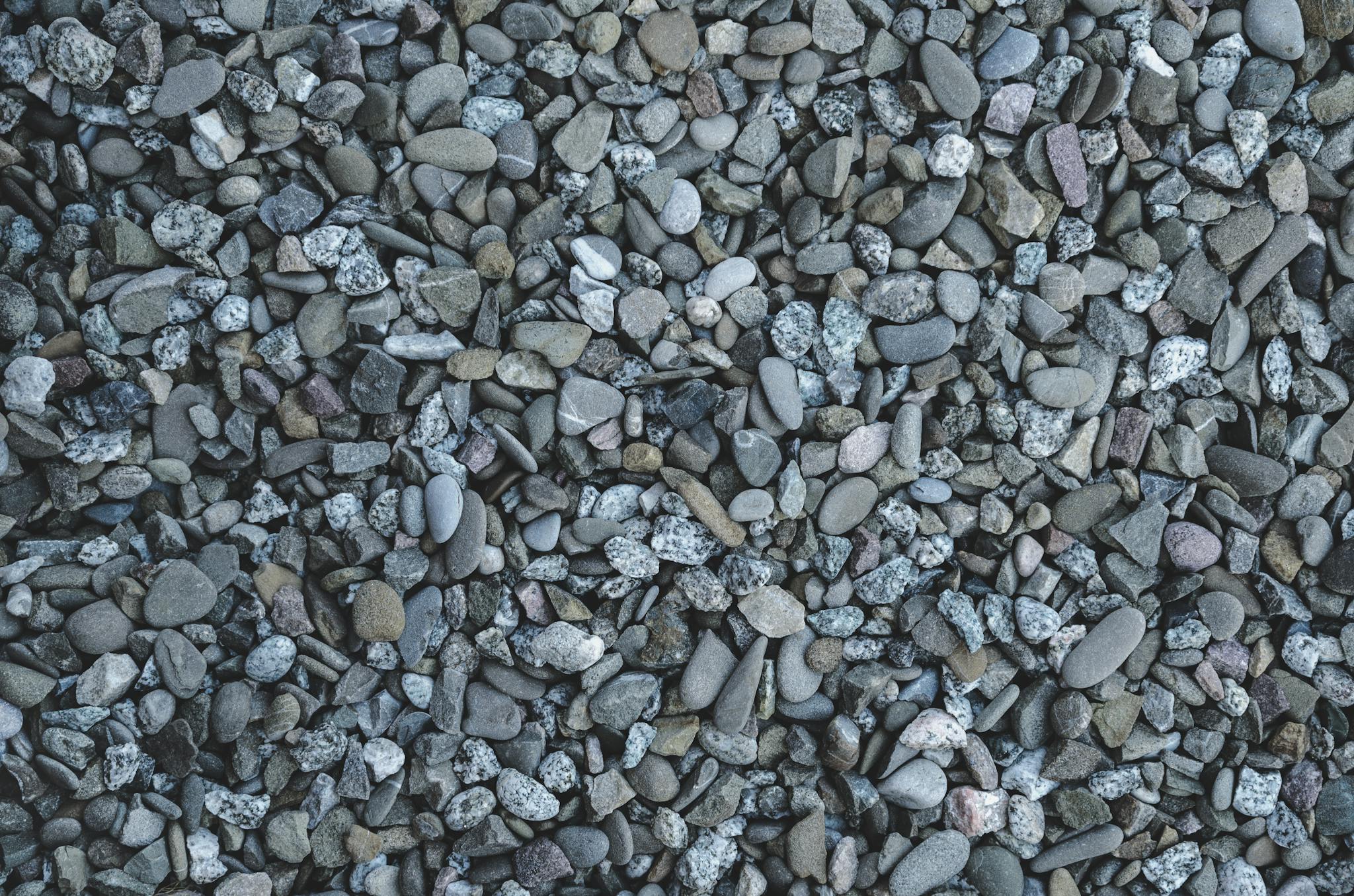 High-resolution closeup of assorted pebbles creating a textured stone background.